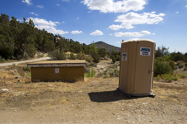 A portable toilet is shown on Ponderosa Lane in Trout Canyon Monday, July 15, 2013. Residents were allowed to return to their homes Sunday but they have no running water.