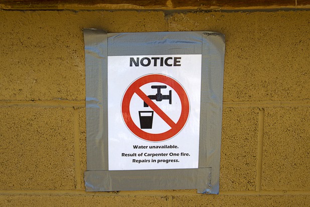 A sign notes the lack of water in Trout Canyon Monday, July 15, 2013. Residents were allowed to return to their homes Sunday.