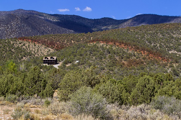 A line of fire retardant is shown behind a home in Trout Canyon Monday, July 15, 2013. Residents were allowed to return to their homes Sunday.