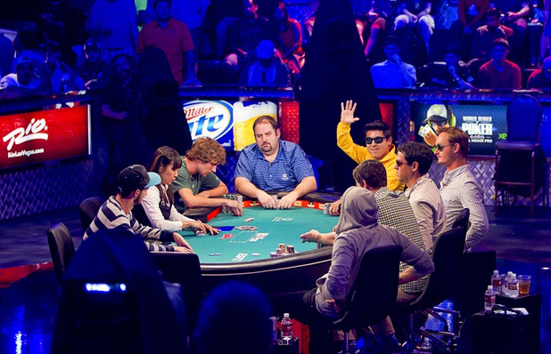 Bruno Kawauti of Brazil waves to supporters as he competes during the seventh day of the World Series of Poker $10,000 buy-in no-limit Texas Hold 'Em at the Rio Monday, July 15, 2013. 