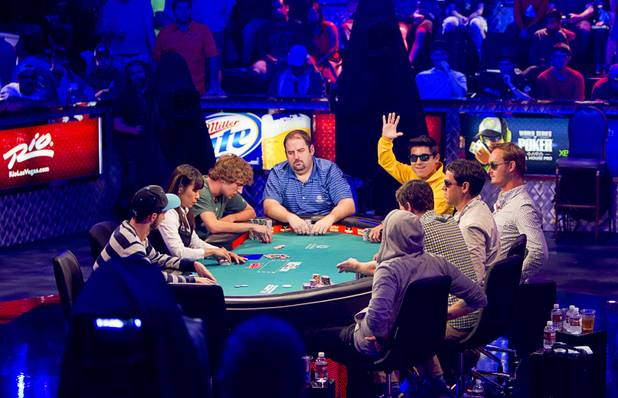 Bruno Kawauti of Brazil waves to supporters as he competes during the seventh day of the World Series of Poker $10,000 buy-in no-limit Texas Hold 'Em at the Rio Monday, July 15, 2013.