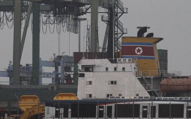 The North Korean-flagged cargo ship Chong Chon Gang, yellow, sits docked at the Manzanillo International container terminal on the coast of Colon City, Panama, early Tuesday, July 16, 2013. Panama's president said the country has seized the ship, carrying what appeared to be ballistic missiles and other arms that had set sail from Cuba.