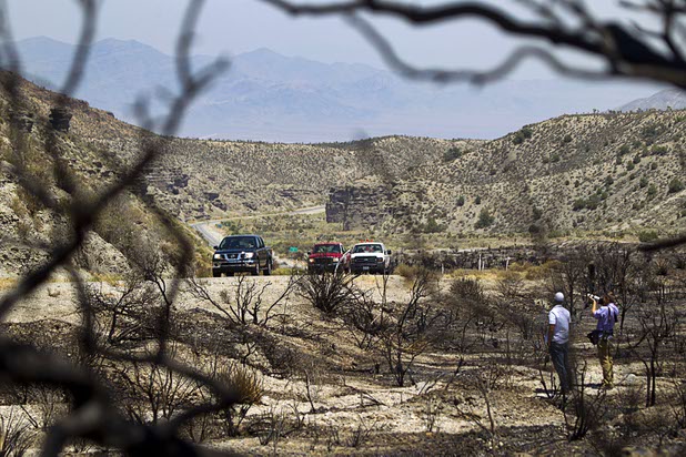 Traffic on Kyle Canyon Road passes a burned area near Harris Springs Road Thursday, July 18, 2013. The mountain is expected to reopen to the public on Friday.