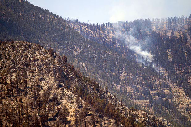 Hot spots continue to smolder on Mount Charleston Thursday, July 18, 2013. The areas is too steep for firefighters and too high in altitude for firefighting helicopters. The mountain is expected to reopen to the public on Friday.