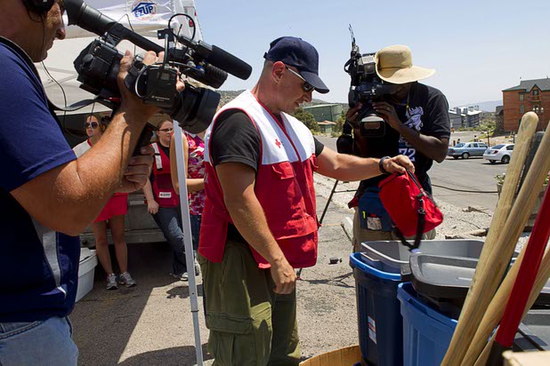 Adrian Meloni, center, of the American Red Cross, displays supplies the organization is making available to residents on Mount Charleston Thursday, July 18, 2013. The mountain is expected to reopen to the public on Friday.