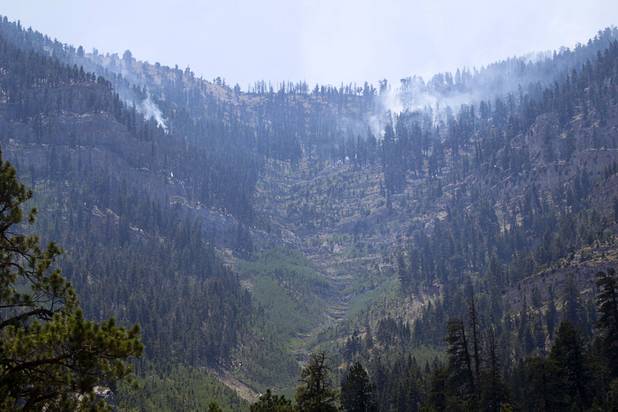 Hot spots continue to smolder on Mount Charleston Thursday, July 18, 2013. The areas is too steep for firefighters and too high in altitude for firefighting helicopters. The mountain is expected to reopen to the public on Friday.