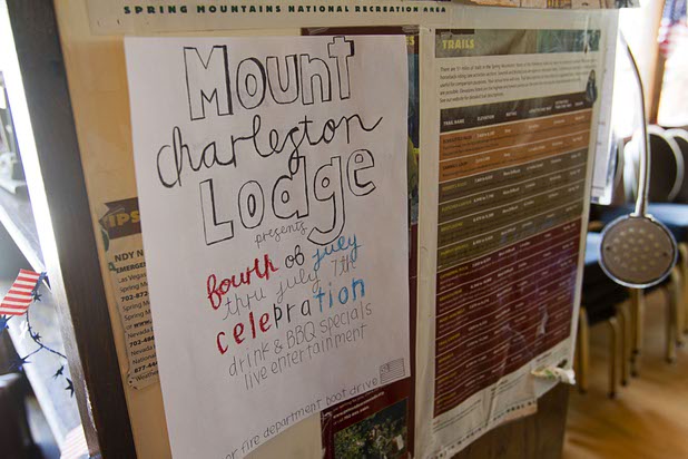 A flyer for July 4th weekend still hangs in the Mount Charleston Lodge Thursday, July 18, 2013. Residents and businesses on the mountain were evacuated on July 4. The mountain is expected to reopen to the public on Friday.