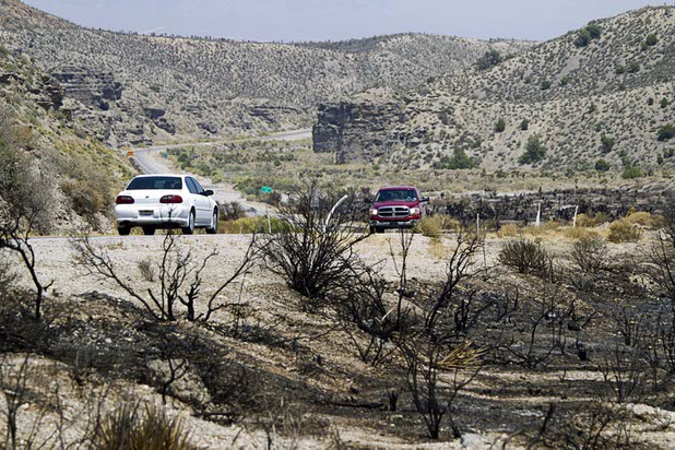 Traffic on Kyle Canyon Road passes a burned area near Harris Springs Road Thursday, July 18, 2013. The mountain is expected to reopen to the public on Friday.