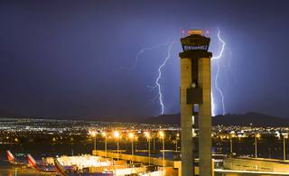 Lightning strikes south of McCarran International Airport as a storm makes its way across the Las Vegas Valley Friday, July 19, 2013.