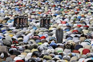 Supporters of Egypt's ousted President Mohammed Morsi offer their Friday prayer in front Rabaah al-Adawiya mosque, where protesters have installed their camp and hold their daily rally, at Nasr City, Cairo, Egypt, Friday, July 19, 2013. 