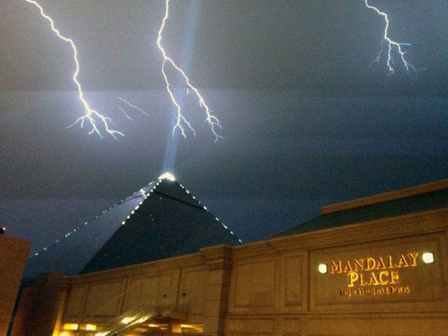 Lightning strikes over Mandalay Bay and the Luxor, Friday, July 19, 2013.