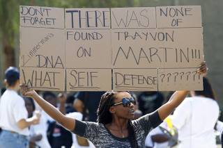 Vena Davis holds a sign during a rally on the one week anniversary of George Zimmerman's acquittal in the killing of Trayvon Martin Saturday, July 20, 2013.