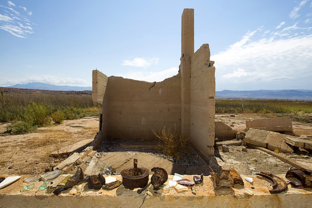Broken glass and rusted pieces of metal are shown on a wall at the town of St. Thomas in the Lake Mead National Recreation Area Monday, July 22, 2013. The town started as a farming settlement in 1865 but was covered by the rising waters of Lake Mead in the 1930's after the construction of Hoover Dam.