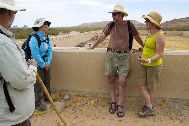 Steve Daron, left, Lake Mead National Recreation Area cultural resource manager, and archeologist Glendee Ane Osbourne speak with visitors Rick Rybeck and his wife Ellen Czaplewski of Washington D.C. at the town of St. Thomas in the Lake Mead National Recreation Area Monday, July 22, 2013. The town started as a farming settlement in 1865 but was covered by the rising waters of Lake Mead in the 1930's after the construction of Hoover Dam.