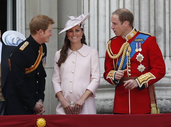 Britain's Prince Harry, left, Kate, Duchess of Cambridge, center, and Prince William, on the balcony of Buckingham Palace, during the Trooping The Colour parade, in London, Saturday, June 15, 2013.