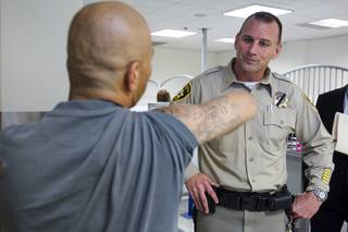 An inmate shows a gang tattoo to Metro Corrections Captain Rich Suey during a tour of the Clark County Detention Center Tuesday, July 23, 2013.