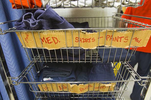 Shirts and pants are shown in baskets in a booking area during a tour of the Clark County Detention Center Tuesday, July 23, 2013.