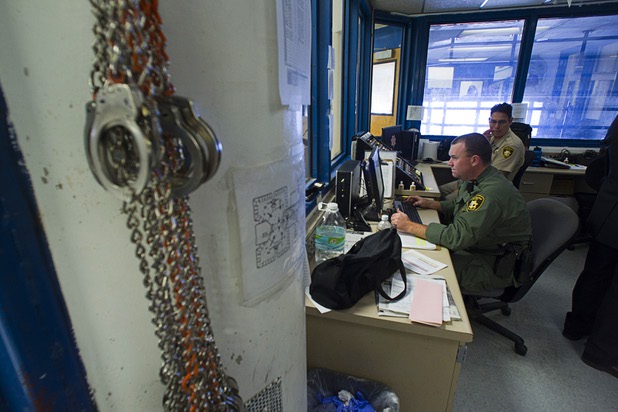 Corrections officer Jared Senior works on a report at a max intensive protective custody area during a tour of the Clark County Detention Center Tuesday, July 23, 2013.