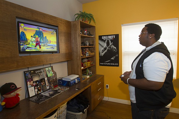 Sean Adams plays a video game in his apartment at Crossings at St. Jude's, a supportive housing program for homeless 18 to 25-year-olds, Tuesday, July 23, 2013. Adams works as a warehouse manager at St. Jude's Ranch in Boulder City.