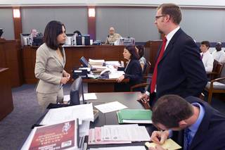 Deputy Public Defenders Nadia Hojjat, left, and Robert O'Brien confer in court Tuesday, July 23, 2013.