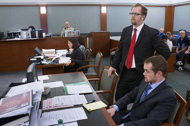Clark County Deputy Public Defender Robert O'Brien, standing, and law clerk Christopher Peterson wait for court to start at the Regional Justice Center  Tuesday, July 23, 2013.