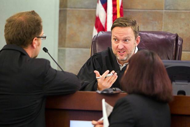 Clark County Deputy Public Defender Robert O'Brien, left, and Deputy District Attorney Ofelia Monje confer with Judge Eric Gooman at the Regional Justice Center  Tuesday, July 23, 2013.