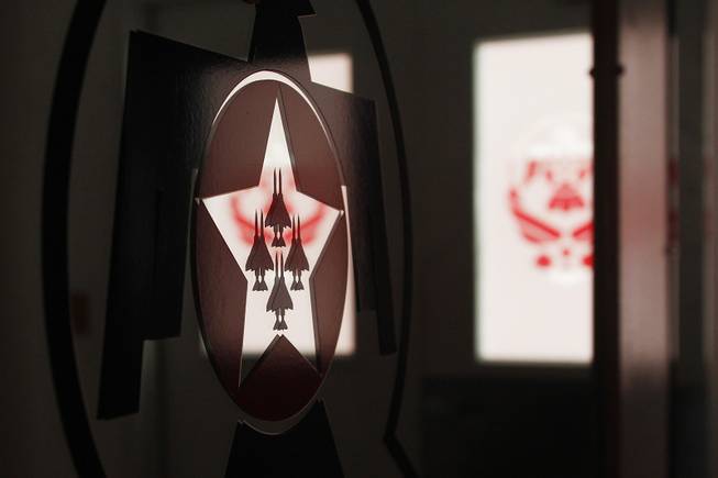 The Thunderbird's logo is seen on a mirror in their hangar at Nellis Air Force Base Tuesday, July 22, 2013.