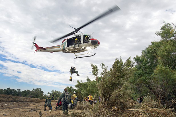 In this Aug. 23, 2012, file photo, an officer deploys from a Metro Police search and rescue helicopter. An officer died Monday, July 22, 2013, during the rescue of a stranded hiker on Mount Charleston, authorities said.

