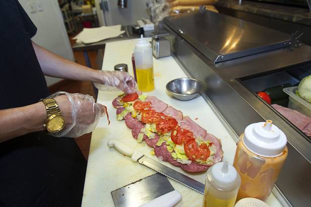 Dylan Jones makes an Italian sub at the Capriotti's sandwich shop, 90 S. Stephanie St., in Henderson Wednesday, July 24, 2013.