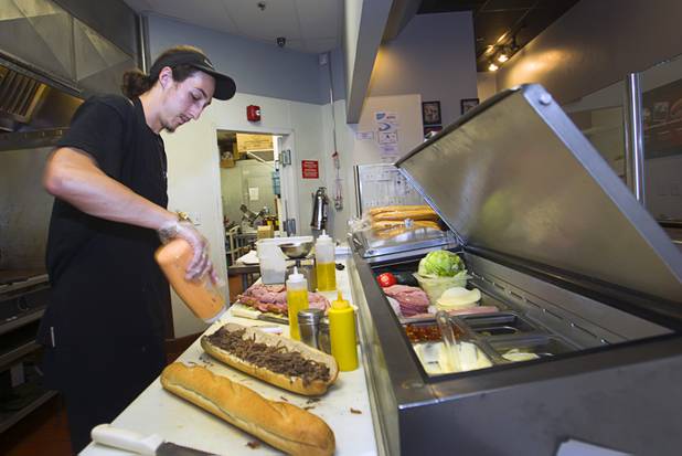 Dylan Jones works on a '"SlawBeJoe" at the Capriotti's sandwich shop, 90 S. Stephanie St., in Henderson Wednesday, July 24, 2013.