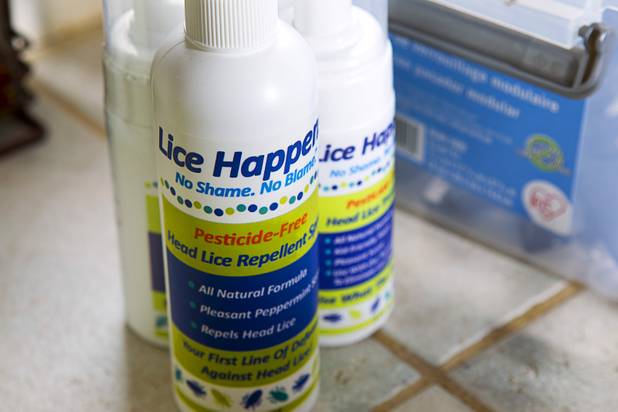 Bottles of non-toxic, pesticide-free head lice repellent are displayed Michelle Lohrli's home Sunday, July 28, 2013. The business is part of a national franchise system.