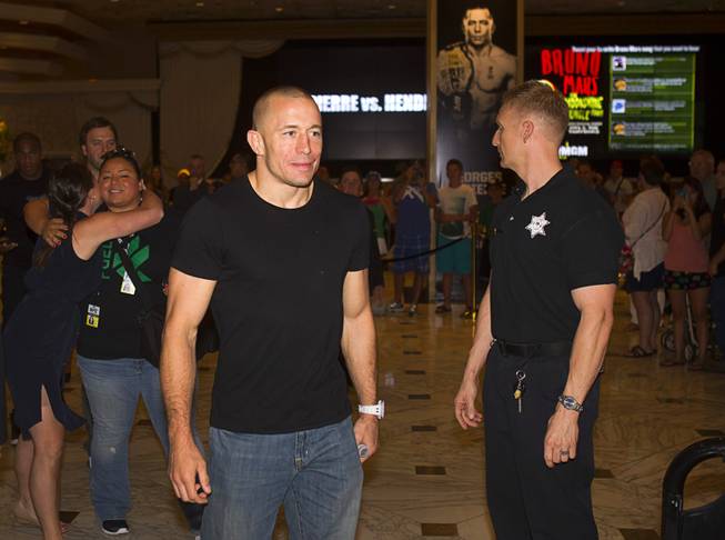 UFC welterweight champion Georges St. Pierre of Canada arrives for a UFC news conference in the lobby of the MGM Grand Monday, July 29, 2013. St. Pierre will defend his welterweight title against Johny Hendricks of Dallas, Texas during UFC 167 on Nov. 17 at the MGM Grand.