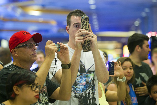 UFC fans take photos of UFC welterweight champion Georges St. Pierre of Canada and Johny Hendricks of Dallas, Texas during a UFC news conference in the lobby of the MGM Grand Monday, July 29, 2013. St. Pierre will defend his welterweight title against Hendricks during UFC 167 on Nov. 17 at the MGM Grand.