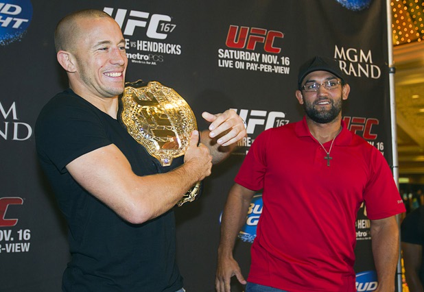 UFC welterweight champion Georges St. Pierre, left, of Canada poses Johny Hendricks of Dallas, Texas pose during a UFC news conference in the lobby of the MGM Grand Monday, July 29, 2013. St. Pierre will defend his welterweight title against Hendricks during UFC 167 on Nov. 17 at the MGM Grand.