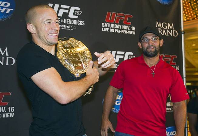 UFC welterweight champion Georges St. Pierre, left, of Canada poses Johny Hendricks of Dallas, Texas pose during a UFC news conference in the lobby of the MGM Grand Monday, July 29, 2013. St. Pierre will defend his welterweight title against Hendricks during UFC 167 on Nov. 17 at the MGM Grand.