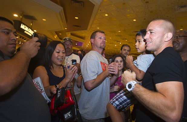 UFC welterweight champion Georges St. Pierre, right, of Canada poses with Victor Montesdeoza, 3, during a UFC news conference in the lobby of the MGM Grand Monday, July 29, 2013. St. Pierre will defend his welterweight title against Johny Hendricks of Dallas, Texas during UFC 167 on Nov. 17 at the MGM Grand.