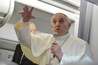 Pope Francis gestures as he answers reporters questions during a news conference aboard the papal flight on the journey back from Brazil, Monday, July 29, 2013. Pope Francis reached out to gays on Monday, saying he wouldn't judge priests for their sexual orientation in a remarkably open and wide-ranging news conference as he returned from his first foreign trip. 