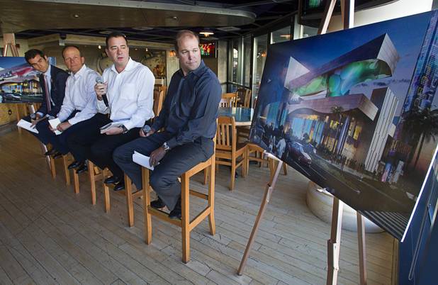 Speakers look over an artist's illustration of Caesars Entertainment's Linq development before a construction tour of the project Tuesday, July 29, 2013. From left are:  Jon Gray, Linq vice president and general manager, David Codiga, Linq executive project director, Branislav Hetzel, CEO of Hetzel Design, and Brian Fink, associate principal with Klai Juba Architects. The $550 million shopping, dining and entertainment district will be anchored by the 550-foot-tall High Roller observation wheel. The project's first phase is expected to open in late 2013.