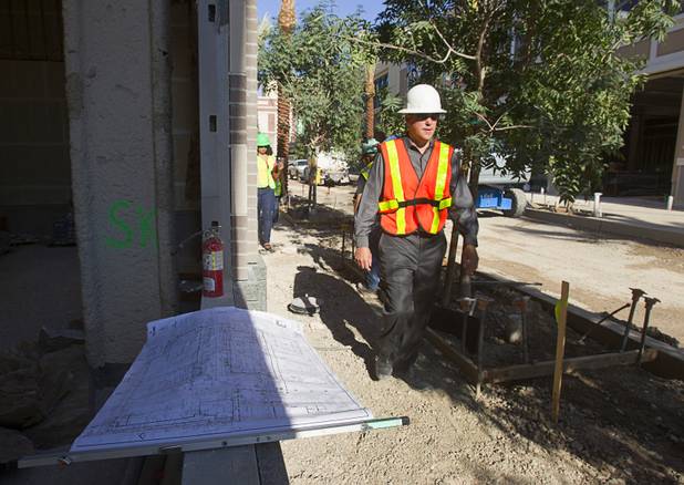 Brian Fink, associate principal with Klai Juba Architects, walks by plans during a tour of Caesar Entertainment's Linq development Tuesday, July 29, 2013. The $550 million shopping, dining and entertainment district will be anchored by the 550-foot-tall High Roller observation wheel. The project's first phase is expected to open in late 2013.