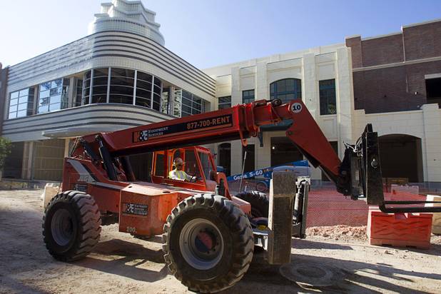 A fork lift operator drives through the Caesars Entertainment's Linq development Tuesday, July 29, 2013. The $550 million shopping, dining and entertainment district will be anchored by the 550-foot-tall High Roller observation wheel. The project's first phase is expected to open in late 2013.