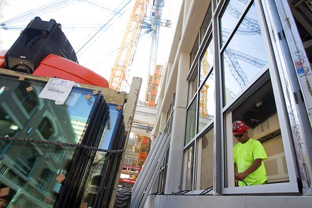 A worker installs window stripping during a tour of Caesars Entertainment's Linq development Tuesday, July 29, 2013. The $550 million shopping, dining and entertainment district will be anchored by the 550-foot-tall High Roller observation wheel. The project's first phase is expected to open in late 2013.