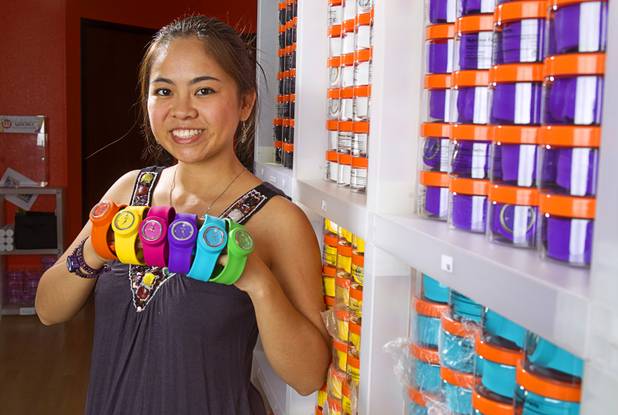 Designer Winky Wu poses with slap band watches in her office Tuesday, July 30, 2013. Wu is founder of Winky Designs, a Vegas-based company that makes accessories like bright, fun watches, purses and belts.