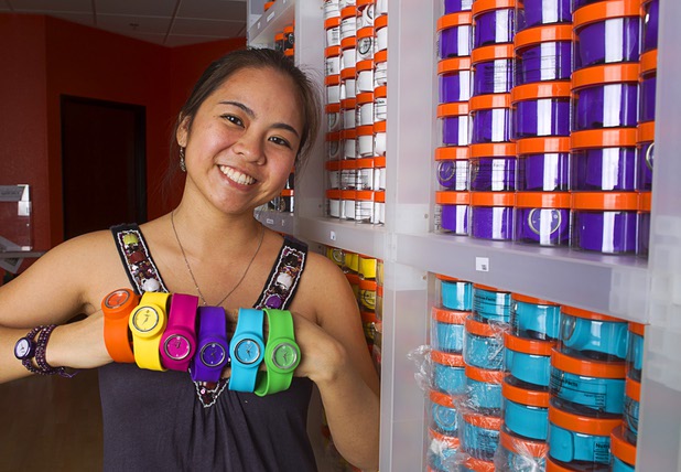 Designer Winky Wu poses with slap band watches in her office Tuesday, July 30, 2013. Wu is founder of Winky Designs, a Vegas-based company that makes accessories like bright, fun watches, purses and belts.