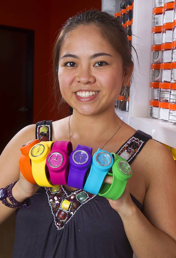 Designer Winky Wu poses with slap band watches in her office Tuesday, July 30, 2013. Wu is founder of Winky Designs, a Vegas-based company that makes accessories like bright, fun watches, purses and belts.