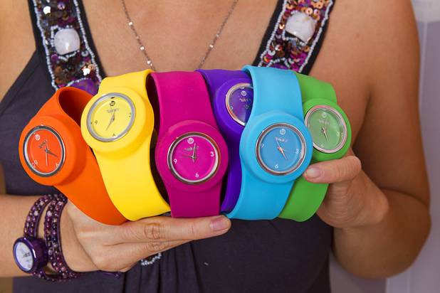 Designer Winky Wu poses with slap band watches in her office Tuesday, July 30, 2013. Wu is founder of Winky Designs, a Vegas-based company that makes accessories like bright, fun watches, purses and belts.