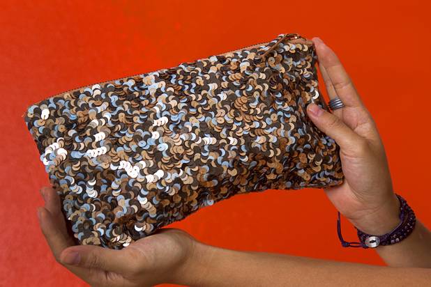 Designer Winky Wu holds a " Oh So Clutch" sequin clutch purse in her office Tuesday, July 30, 2013. Wu is founder of Winky Designs, a Vegas-based company that makes accessories like bright, fun watches, purses and belts.