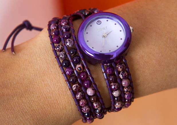 Designer Winky Wu models an "On the Rocks" watch in her office Tuesday, July 30, 2013. The band is made up of semiprecious stones hand-woven through leather bracelets.