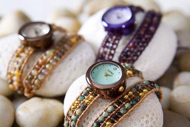 Watches from the "On the Rocks" collection are displayed at Winky Designs Tuesday, July 30, 2013. The band is made up of semiprecious stones hand-woven through leather bracelets.