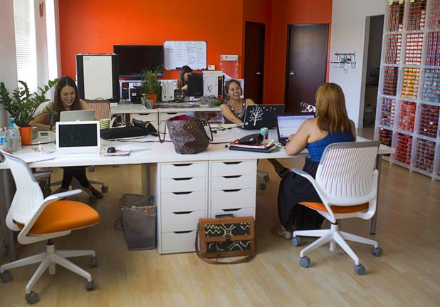 Designer Winky Wu, second right, works in her office Tuesday, July 30, 2013. Wu is founder of Winky Designs, a Vegas-based company that makes accessories like bright, fun watches, purses and belts.