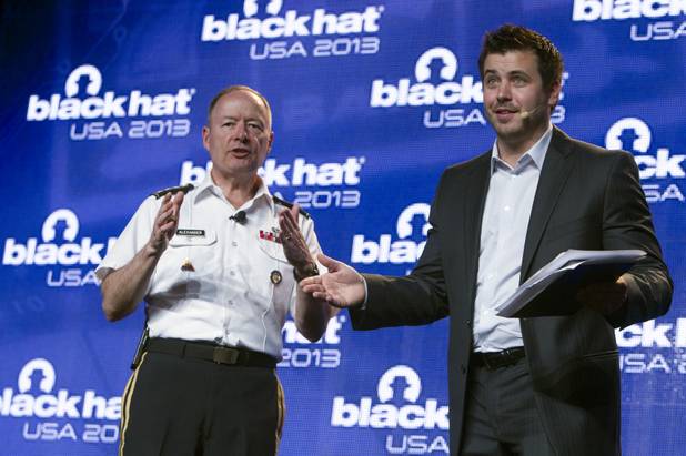 Trey Ford, right, general manager of Black Hat USA 2013, moderates a question and answer session with General Keith Alexander, director of the National Security Agency (NSA), chief of the Central Security Service (CSS), and commander of the U.S. Cyber Command, during the hacker convention at Caesars Palace Wednesday, July 31, 2013.